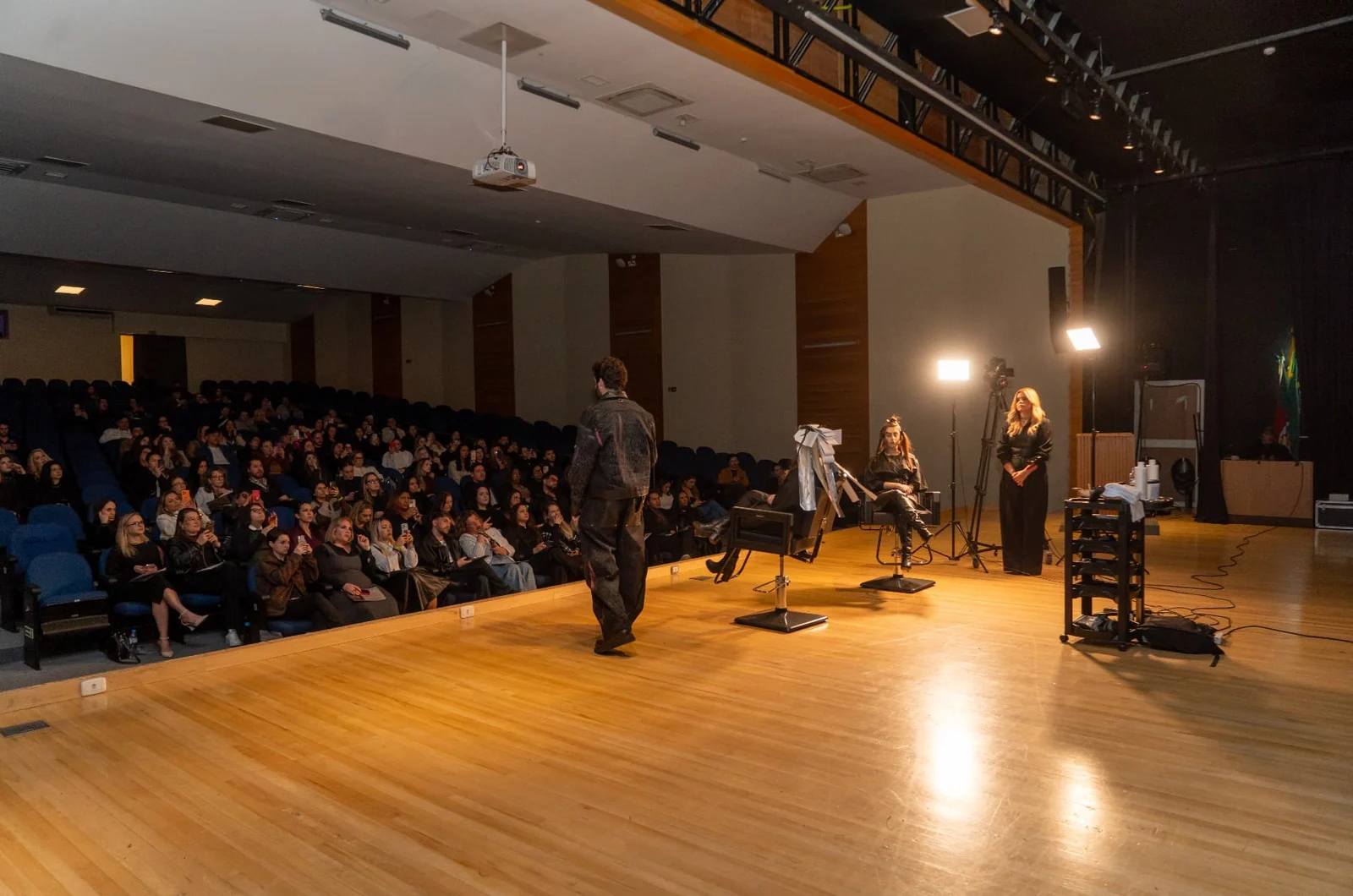 Palco iluminado diante de auditório cheio